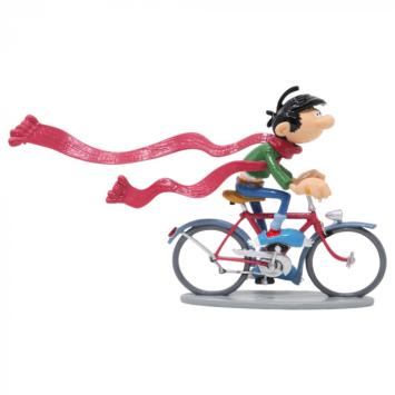 Guust Flater op zijn fiets met een lange sjaal